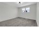 This bedroom features neutral walls, gray carpet, and a light fixture at 8694 E Eastman Ave, Denver, CO 80231