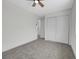 Bedroom with a ceiling fan, plush carpet, and a double door closet at 8694 E Eastman Ave, Denver, CO 80231