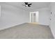 Spacious bedroom with neutral carpet, fan, and ample closet space at 8694 E Eastman Ave, Denver, CO 80231