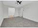 A carpeted bedroom with multiple doors and access to closets at 8694 E Eastman Ave, Denver, CO 80231