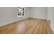 Bedroom with wood floors, white trim, and a window providing ample natural light at 8694 E Eastman Ave, Denver, CO 80231