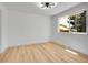 Bright bedroom with hardwood floors, modern lighting, and a large window at 8694 E Eastman Ave, Denver, CO 80231