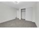 Spacious bedroom with gray carpet, neutral walls, closet, and natural light at 8694 E Eastman Ave, Denver, CO 80231