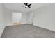 Cozy bedroom featuring neutral walls, plush carpet, access to multiple closets, and updated lighting at 8694 E Eastman Ave, Denver, CO 80231