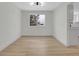 Dining room featuring wood floors, modern lighting, and an open layout at 8694 E Eastman Ave, Denver, CO 80231