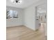Bright dining room featuring wood floors, an open layout, and modern lighting at 8694 E Eastman Ave, Denver, CO 80231