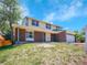 Charming two-story home featuring a brick facade, two-car garage, and a well-maintained front yard at 8694 E Eastman Ave, Denver, CO 80231
