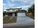 Two-story home featuring a two-car garage and a well-maintained lawn at 8694 E Eastman Ave, Denver, CO 80231