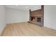 Cozy living room with a brick fireplace with a stone hearth and wood flooring at 8694 E Eastman Ave, Denver, CO 80231