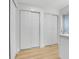 Hallway with wood floors and closet with sliding doors at 8694 E Eastman Ave, Denver, CO 80231
