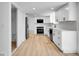 Spacious kitchen with stainless steel appliances, white cabinets, and wood flooring at 8694 E Eastman Ave, Denver, CO 80231