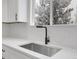 Modern kitchen sink with quartz countertops and black faucet offers style and function at 8694 E Eastman Ave, Denver, CO 80231