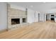 Spacious living room featuring a gray brick fireplace and wood flooring at 8694 E Eastman Ave, Denver, CO 80231