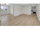 Spacious living room featuring wood floors, neutral paint, and staircase access at 8694 E Eastman Ave, Denver, CO 80231