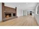 Cozy living room with a brick fireplace with a stone hearth and wood flooring at 8694 E Eastman Ave, Denver, CO 80231