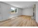 Bright living room with new flooring, window and fireplace at 8694 E Eastman Ave, Denver, CO 80231