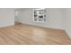 Inviting living room featuring wood floors, a bay window, and neutral paint at 8694 E Eastman Ave, Denver, CO 80231