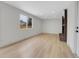 Bright living room showcasing a brick fireplace, large windows, and modern flooring at 8694 E Eastman Ave, Denver, CO 80231