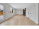 Bright living room featuring wood floors, a brick fireplace and an abundance of natural light at 8694 E Eastman Ave, Denver, CO 80231