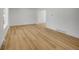 Bright and open living room with light hardwood floors and neutral walls at 8694 E Eastman Ave, Denver, CO 80231