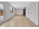 Spacious living room features new floors, brick fireplace, and plenty of natural light at 8694 E Eastman Ave, Denver, CO 80231