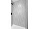 Modern shower featuring wavy tile and a black shower head at 8694 E Eastman Ave, Denver, CO 80231