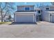 Two-story house with large garage and an asphalt driveway at 12561 E Cornell Cir, Aurora, CO 80014