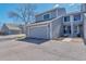 Charming two-story home featuring a large garage and a well-maintained front yard at 12561 E Cornell Cir, Aurora, CO 80014