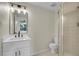 Bright bathroom featuring a vanity with a solid surface top, framed mirror, and a walk-in shower at 1717 Tulip St, Longmont, CO 80501