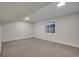 This secondary bedroom features neutral carpet, baseboard trim, and a window with a view to the outside at 1717 Tulip St, Longmont, CO 80501