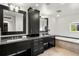 Elegant bathroom with double sinks, granite counters, and a soaking tub at 1804 Little Raven St, Denver, CO 80202