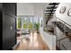 Bright entryway with hardwood floors, modern staircase, and large windows at 1804 Little Raven St, Denver, CO 80202