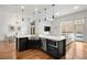 Modern kitchen with large island, stainless steel appliances, and hardwood floors at 1804 Little Raven St, Denver, CO 80202