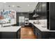 Modern kitchen with dark cabinetry, stainless steel appliances, and white countertops at 1804 Little Raven St, Denver, CO 80202