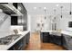 Modern kitchen with dark cabinetry, stainless steel appliances, and an island at 1804 Little Raven St, Denver, CO 80202