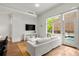 Spacious living room with white couch, large windows and hardwood floors at 1804 Little Raven St, Denver, CO 80202