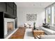 Spacious living room featuring a modern fireplace and hardwood floors at 1804 Little Raven St, Denver, CO 80202
