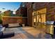 Brick patio with seating area, grill, and city views at dusk at 1804 Little Raven St, Denver, CO 80202
