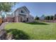 Spacious backyard featuring manicured lawn, mature trees, patio seating and perimeter wood fence at 2195 S Espana St, Aurora, CO 80013