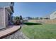 Backyard with grass, brick patio, and black wrought iron seating near a wooden fence at 2195 S Espana St, Aurora, CO 80013