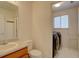 Functional bathroom with a sink, toilet, and easy access to a laundry room at 2195 S Espana St, Aurora, CO 80013