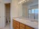 Well-lit bathroom with dual sinks, a large mirror, and a combined shower and tub at 2195 S Espana St, Aurora, CO 80013