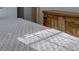 Bedroom with a view of a wooden dresser next to a white quilt bed at 2195 S Espana St, Aurora, CO 80013