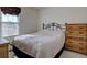 Comfortable bedroom with a decorative iron bed frame and natural light from the window at 2195 S Espana St, Aurora, CO 80013