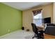 Bedroom with neutral carpet and walls, window with blinds, and office setup at 2195 S Espana St, Aurora, CO 80013