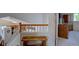 Hallway between the first and second floor with a wooden banister and a bench at 2195 S Espana St, Aurora, CO 80013