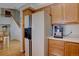 Kitchen featuring light wood cabinets, modern appliances, and hardwood floors with a view of the staircase at 2195 S Espana St, Aurora, CO 80013