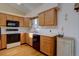 Kitchen with light wood cabinets, modern appliances, and hardwood floors at 2195 S Espana St, Aurora, CO 80013