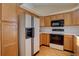 Kitchen with light wood cabinets, modern appliances, and hardwood floors at 2195 S Espana St, Aurora, CO 80013