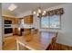 Inviting kitchen with wood cabinets, dining area and a window letting in natural light at 2195 S Espana St, Aurora, CO 80013